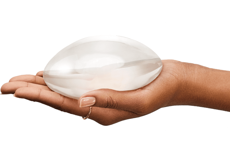 Hand Holding Breast Implant